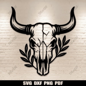 May include: Black metal bull skull wall art with curved horns and a decorative leaf design. The skull features detailed bone structure and is mounted on a white brick wall. The text "SVG DXF PNG PDF" is at the bottom.