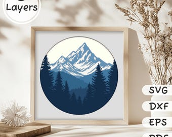 May include: A digital illustration of a mountain range with snow-capped peaks and a forest in the foreground. The image is in a circle and has a blue and white color scheme.