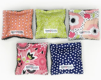 May include: Five square-shaped fabric catnip toys with different patterns. The toys are all gray on the back and have a white label with the text "ZiggetyPets.com Happy Pet - Happy Home".
