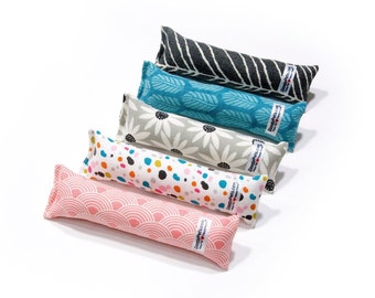 May include: Five colorful catnip toys with different patterns. The toys are made of fabric and are shaped like long pillows. The toys are all lined up in a row, with the black and white striped toy at the top and the pink and white toy at the bottom.