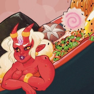May include: A red demon with horns and a gold crown is sitting in a bowl of ramen. The ramen has noodles, eggs, seaweed, and other toppings. The bowl is black with a red rim and a red heart-shaped handle.