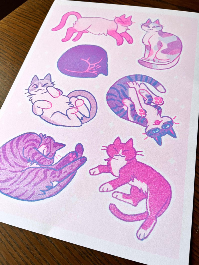 May include: A pink and purple print featuring nine different illustrations of cats in various poses. The cats are drawn in a cartoon style with simple lines and bright colors.