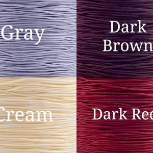 May include: Four spools of cord in different colors: gray, dark brown, cream, and dark red.