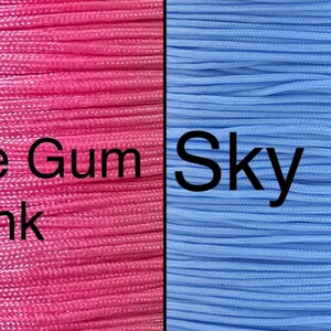 May include: Two spools of cord, one pink and one light blue. The pink spool is labeled "Bubble Gum Pink" and the light blue spool is labeled "Sky Blue".