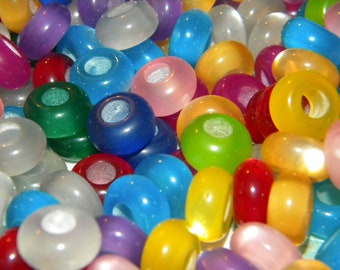 May include: A collection of colorful, translucent beads with a hole in the center. The beads are made of plastic and come in a variety of colors, including red, blue, green, yellow, orange, purple, and pink.