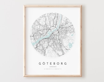 May include: A black and white map of Gothenburg, Sweden, in a circle with a light blue outline. The city name is written in black below the map with the coordinates in smaller font.