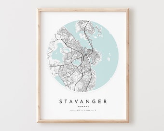 May include: A black and white map of Stavanger, Norway, in a circle on a white background. The map is surrounded by a light blue circle. The city name, "STAVANGER", is printed in black below the map, along with the word "NORWAY" and the coordinates.