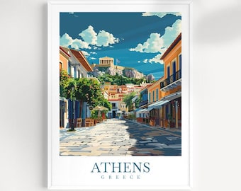 May include: A framed art print depicting a street scene in Athens, Greece. The image shows a cobbled street flanked by buildings in orange and yellow hues. The Acropolis is visible in the background under a blue sky with white clouds. The word "ATHENS" is printed at the bottom.