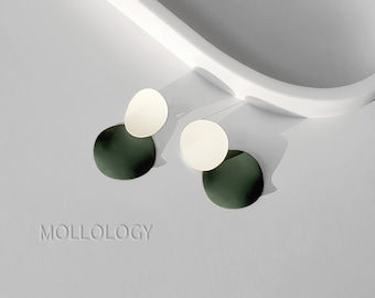 May include: A pair of earrings with a green and white circular design. The earrings are made of metal and have a simple, modern style.