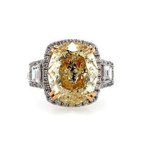 GIA Natural Oval 6.01 cts. Fancy light Yellow Vs2 Diamond set in Halo Ring