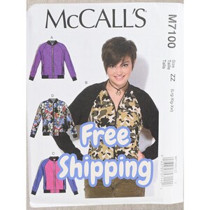 May include: McCall's M7100 sewing pattern envelope featuring illustrations of bomber jackets in purple, floral, and pink colorways. The front displays a model wearing a camouflage print jacket with black sleeves and a front zipper closure.