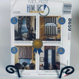 May include: A McCall's Home Dec sewing pattern envelope 8659 featuring four window treatment designs. The white paper envelope displays photographs of curtains, valances, and shades with blue circular icons indicating time estimates for assembly.