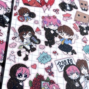 May include: Sheet of glittery stickers featuring anime-style characters with pink hair and various outfits. The stickers include images of characters in different poses, some with speech bubbles and Japanese text. The background is a grid pattern with hearts and other small designs.