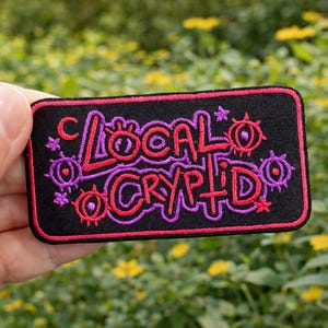 May include: A white ceramic mug with a black handle and the text "But First, Coffee" in a black, bold font. The mug is on a white surface.