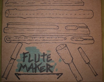 May include: A brown paper bag with the text "Nothos Natural Music" and "Flute Maker" in green ink. The bag shows a series of drawings of wooden planks and tools used to make flutes.