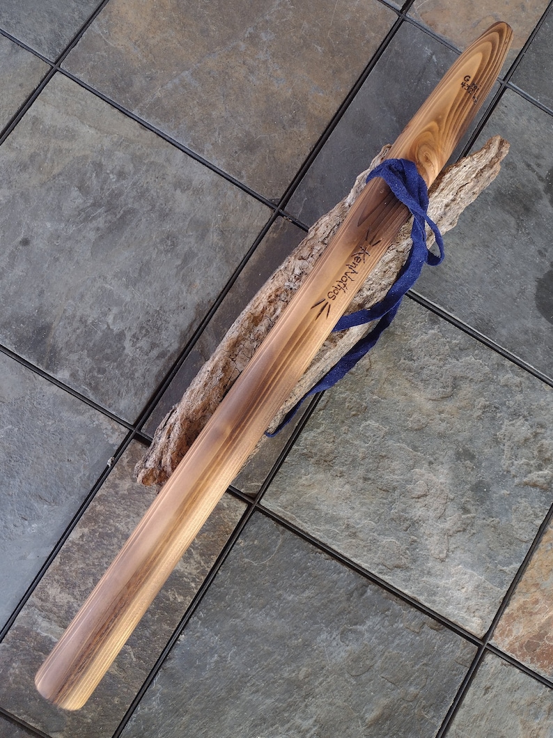 May include: A wooden staff with a blue cord tied around it. The staff is engraved with the words "Kentucky" and "Craftsman".