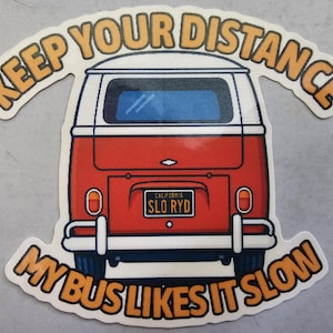 May include: A sticker featuring a red and white vintage van with the text "KEEP YOUR DISTANCE" arched above and "MY BUS LIKES IT SLOW" below. The van has a California license plate that reads "SLO RYD".