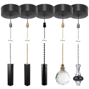 May include: Five black ceiling light pull chains with different decorative ends. The ends include a black cylindrical pull, a crystal ball, a black and gold finial, a gold cylindrical pull, and a silver cylindrical pull.