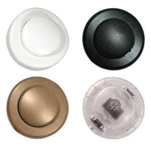May include: Four foot switch pedals in different colours. One is white, one is black, one is bronze, and one is clear. The pedals are round with a raised central button. Used for lamps and other electrical devices.