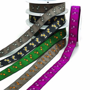 Peut inclure: Un ensemble de six bobines de ruban avec un motif répétitif de chats stylisés. Les rubans sont de différentes couleurs, notamment le brun, le noir, le vert, l'orange et le rose.