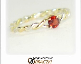 Gold & Silver entwined ring with Garnet