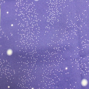 May include: Purple fabric with a white glitter pattern. The fabric has a subtle shimmer and is ideal for crafting projects.