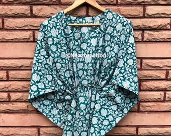 May include: A teal blue and white floral print kimono robe with a V-neck and a tie at the waist.