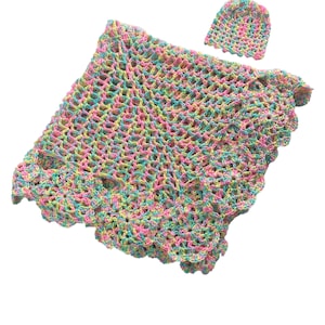 May include: A crocheted baby blanket and hat set in pink, green, and yellow.