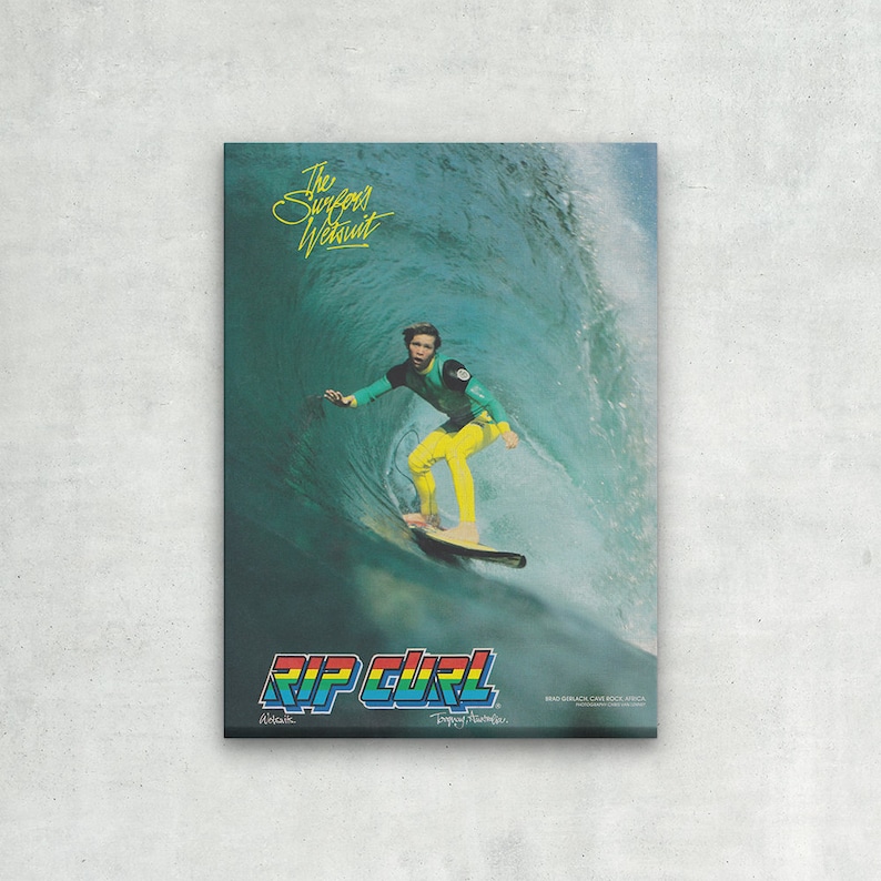 May include: A vintage Rip Curl advertisement featuring a surfer riding a wave. The surfer is wearing a green and yellow wetsuit and a black cap. The text "The Surfsuit Wetsuit" is at the top of the image, and the Rip Curl logo is at the bottom. The text "Brad Gerlach, Carlsbad, Calif." is at the bottom right corner of the image.