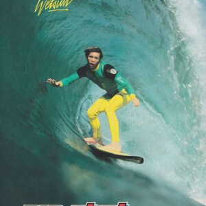 May include: A surfer wearing a green and yellow wetsuit rides a wave. The text "The Surf Wetsuit" is at the top of the image. The text "RIP CURL" is at the bottom of the image. The text "Torquay, Australia" is below the logo.