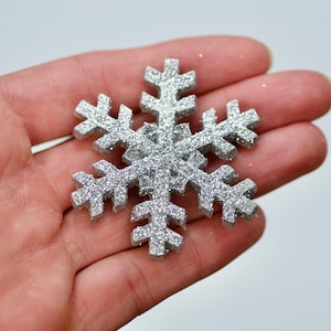 May include: A silver glitter snowflake ornament.