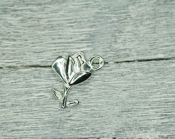 May include: Silver charm in the shape of a rose with a loop for attaching to a bracelet or necklace.