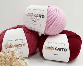 May include: Three skeins of yarn in pink, red, and burgundy. Each skein has a white label with the text "luxury LANA GATTO made in Italy VIP".