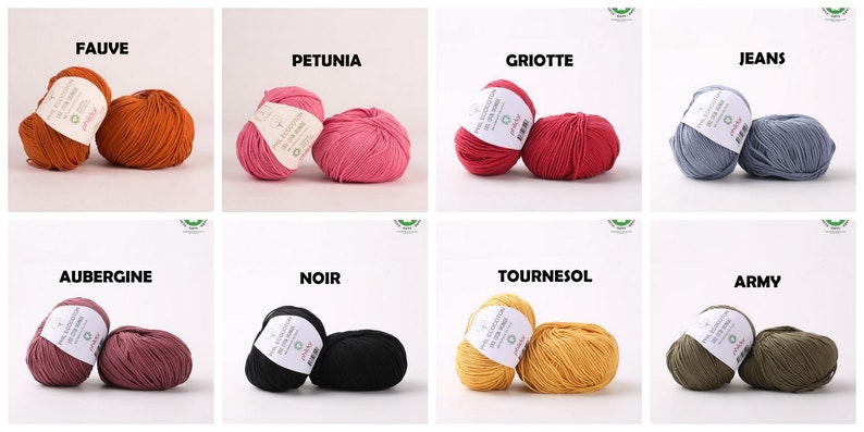May include: Balls of yarn in various colors, including orange, pink, red, blue, purple, black, yellow, and green. The yarn is labeled with the names of the colors in French.