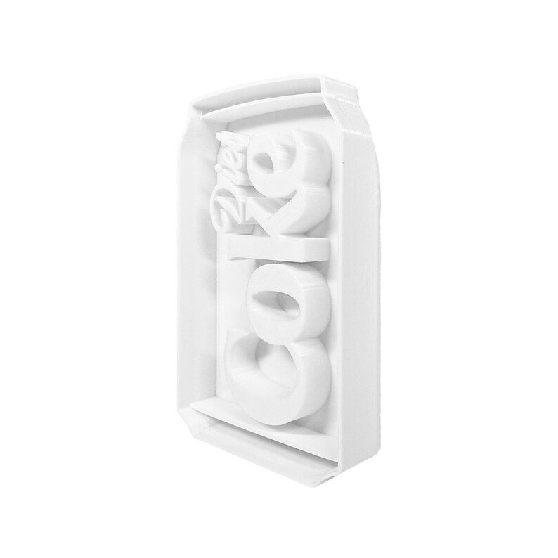 May include: White plastic mold shaped like a can of Coca-Cola. The mold is designed to make ice cubes in the shape of the Coca-Cola logo.