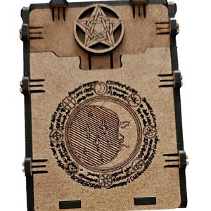 May include: A wooden box with a pentagram design on the top and a moon and stars design on the front. The box is made of dark wood with black accents.