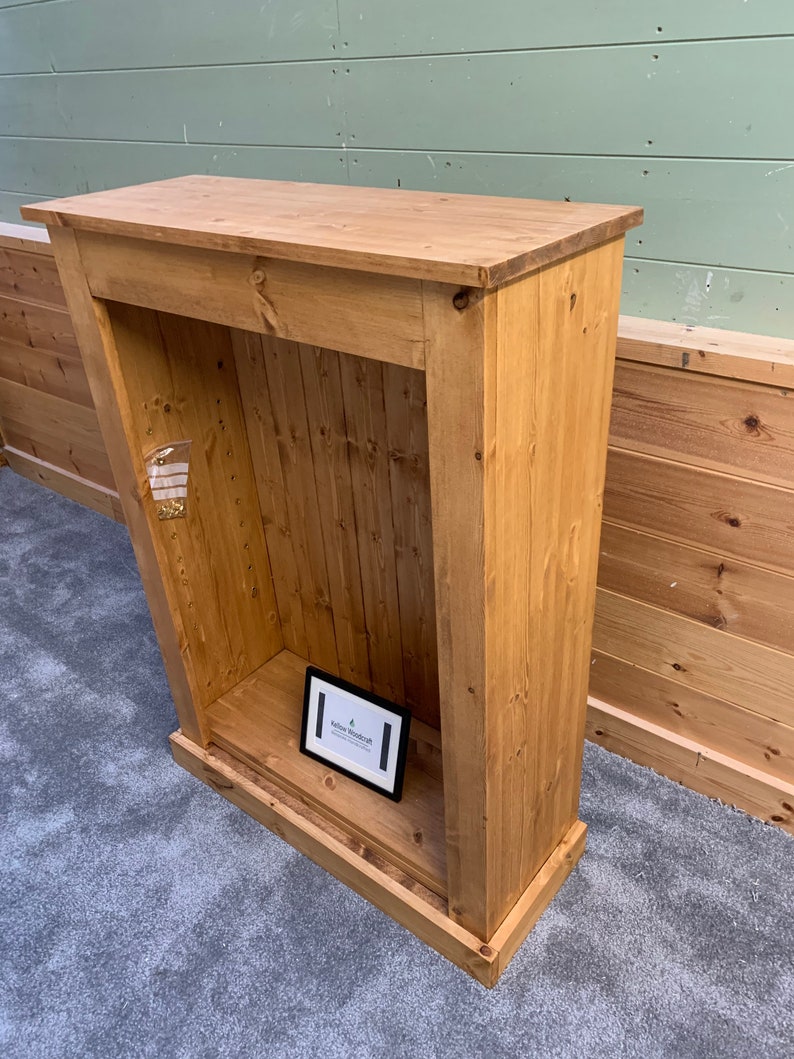 May include: A wooden cabinet with a shelf and a small sign that says "Yellow Woodcraft". The cabinet is made of unfinished pine wood and has a rustic look.