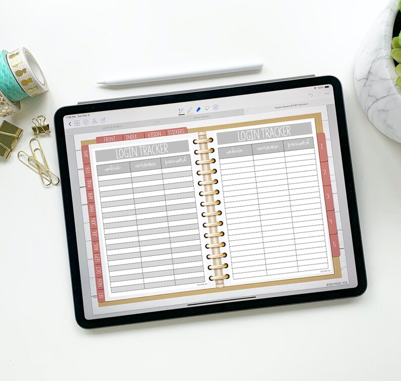 May include: A digital planner open to a page labeled "Login Tracker" with columns for website, username, and password. The planner has a brown cover and gold spiral binding.