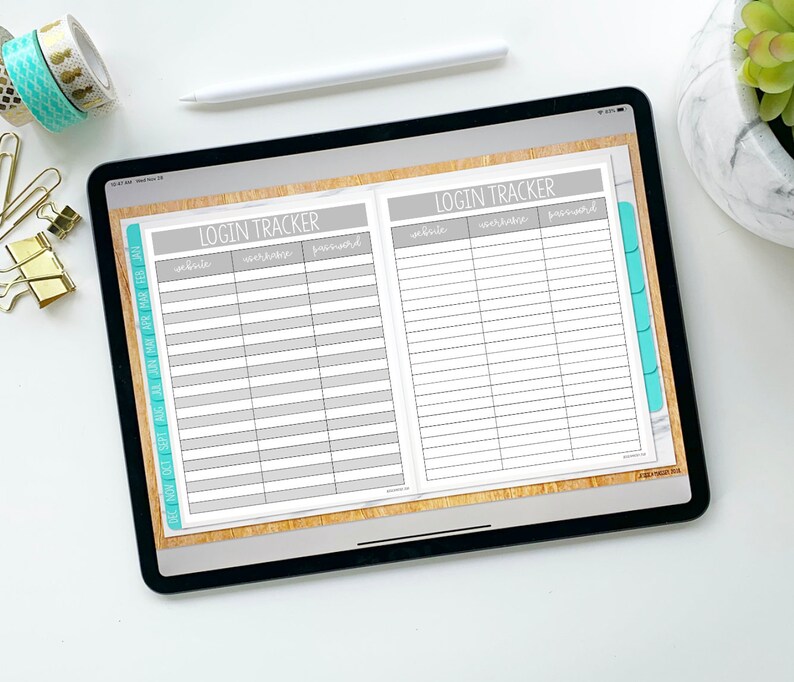 May include: A digital tablet displaying a printable login tracker with columns for website, username, and password. The tracker is on a wood-grain background with teal tabs.