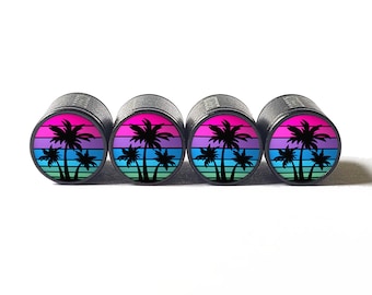 May include: Set of four black valve stem caps with a retro sunset design featuring three palm trees in silhouette. The sunset is a gradient of pink, purple, blue, and green.