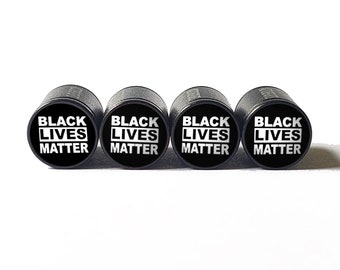 May include: Set of four black valve stem caps with the words "Black Lives Matter" in white lettering.