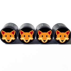 May include: Set of four black tyre valve stem caps with a fox face design. The fox face is orange with a red nose and black eyes.