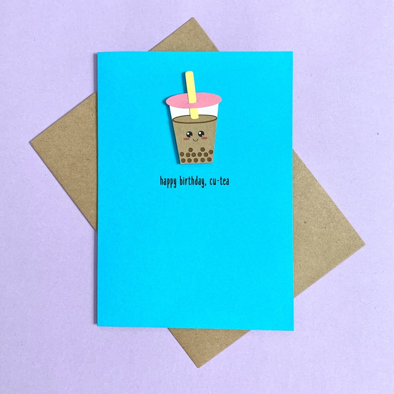 May include: A blue birthday card with a brown and pink bubble tea illustration and the text "happy birthday, cu-tea".