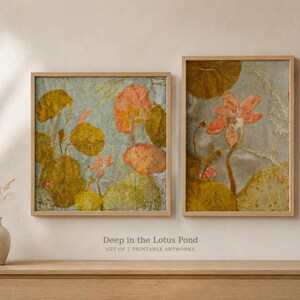 May include: Two framed wall art prints titled Deep in the Lotus Pond, Set of 2 Printable Artworks. The prints feature botanical illustrations of orange lotus flowers and large round green lily pads against a textured light blue background.