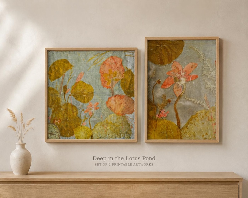 May include: Two framed wall art prints titled Deep in the Lotus Pond, Set of 2 Printable Artworks. The prints feature botanical illustrations of orange lotus flowers and large round green lily pads against a textured light blue background.