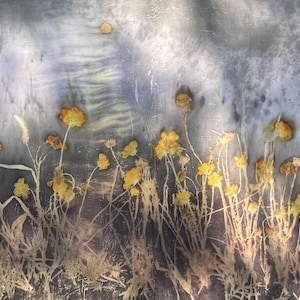 May include: A botanical print on fabric featuring pressed yellow wildflowers with thin stems and leaves against a mottled, textured gray and blue background. The composition displays a field of delicate floral elements with a single small circular shape.