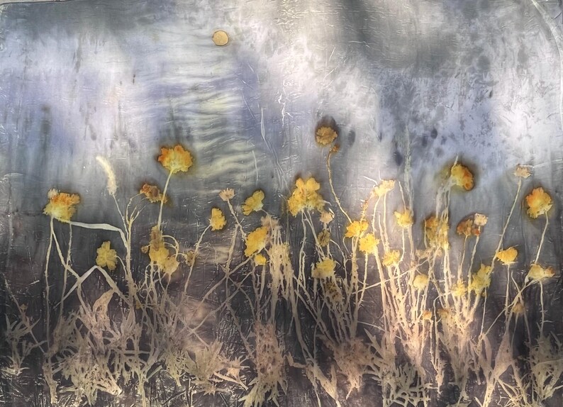 May include: A botanical print on fabric featuring pressed yellow wildflowers with thin stems and leaves against a mottled, textured gray and blue background. The composition displays a field of delicate floral elements with a single small circular shape.