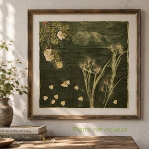 May include: A square textile wall art piece featuring botanical prints of white flowers and green foliage on a dark olive green fabric background. The artwork is displayed within a wooden frame and includes the text Frame not included.