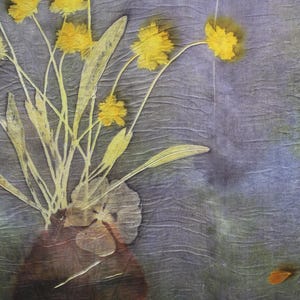 May include: A textile piece featuring a botanical print of yellow flowers in a dark brown vase against a textured, muted purple and green background. The design displays delicate stems, leaves, and flower heads with a visible fabric grain.