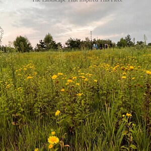 May include: A field of tall green grass and numerous yellow wildflowers under a cloudy sky. The text "The Landscape That Inspired This Piece" is centered at the top of the image. The horizon features a line of dark green trees and distant figures.